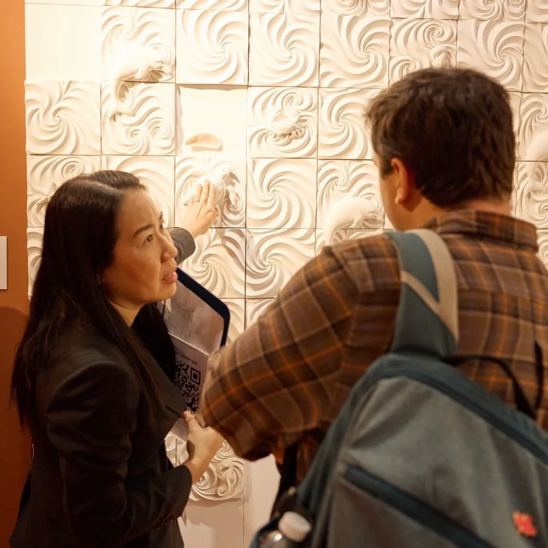 Visitors touching the MyraShell Sea of Love wall at Milan Design Week 2026
