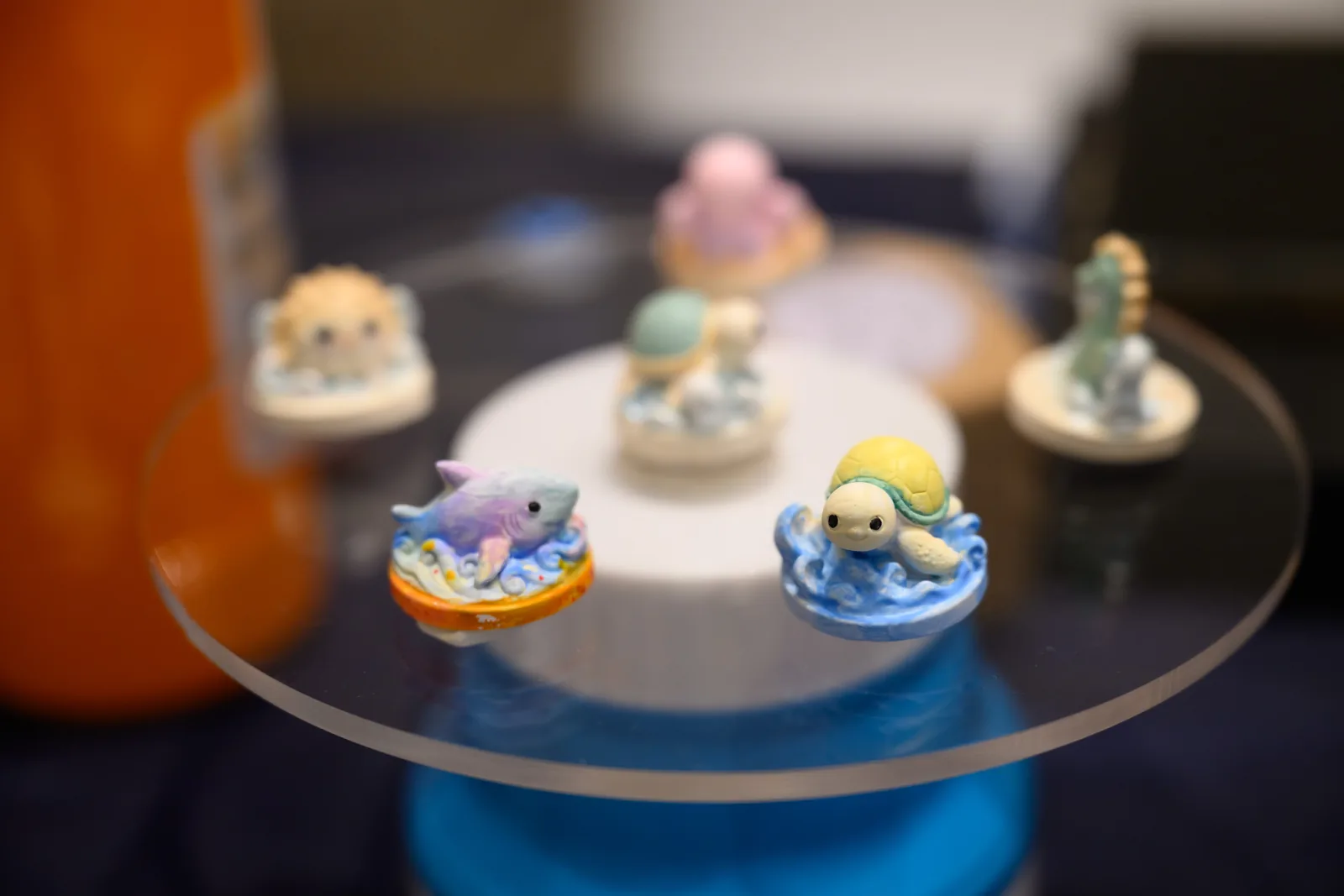 Painted Sea Soul characters on a glass stand