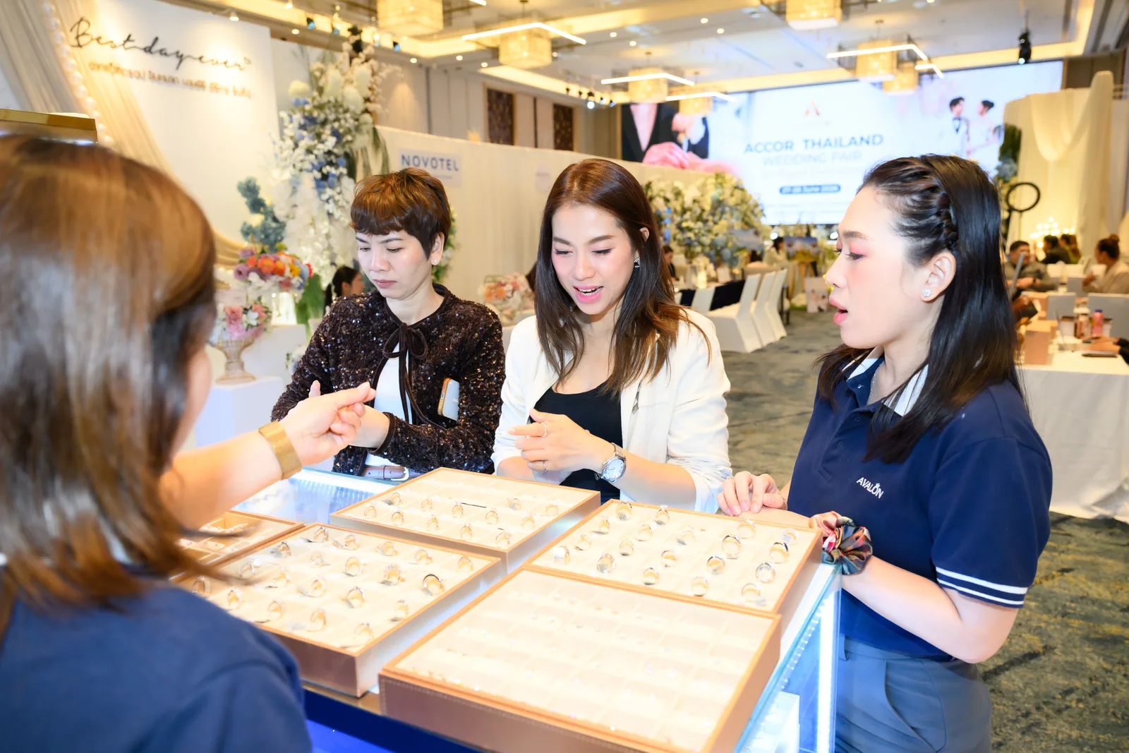 Visitors at the jewelry showcases with our team