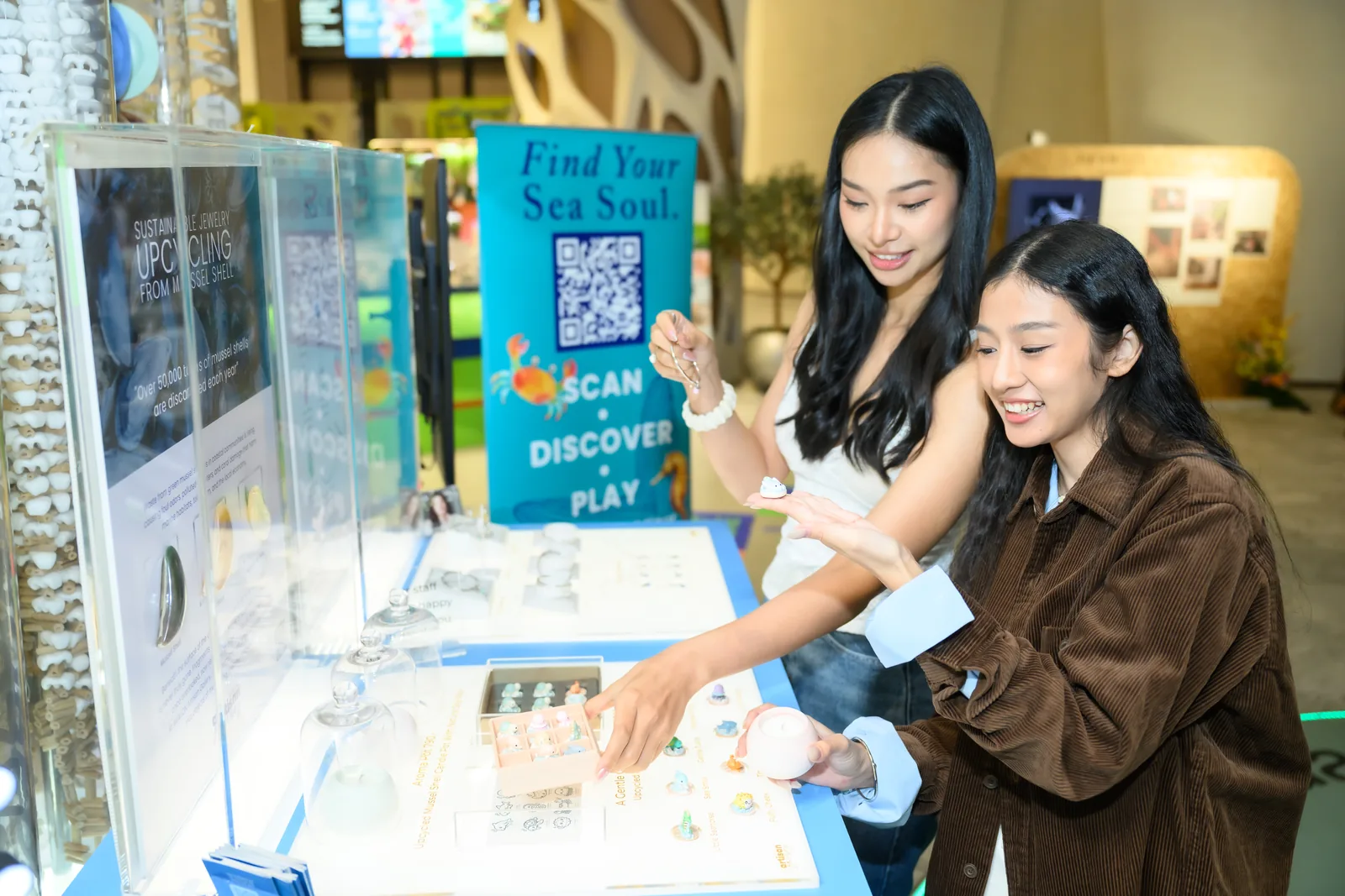 Visitors look at the Sea Soul pieces and XO game box at the cart