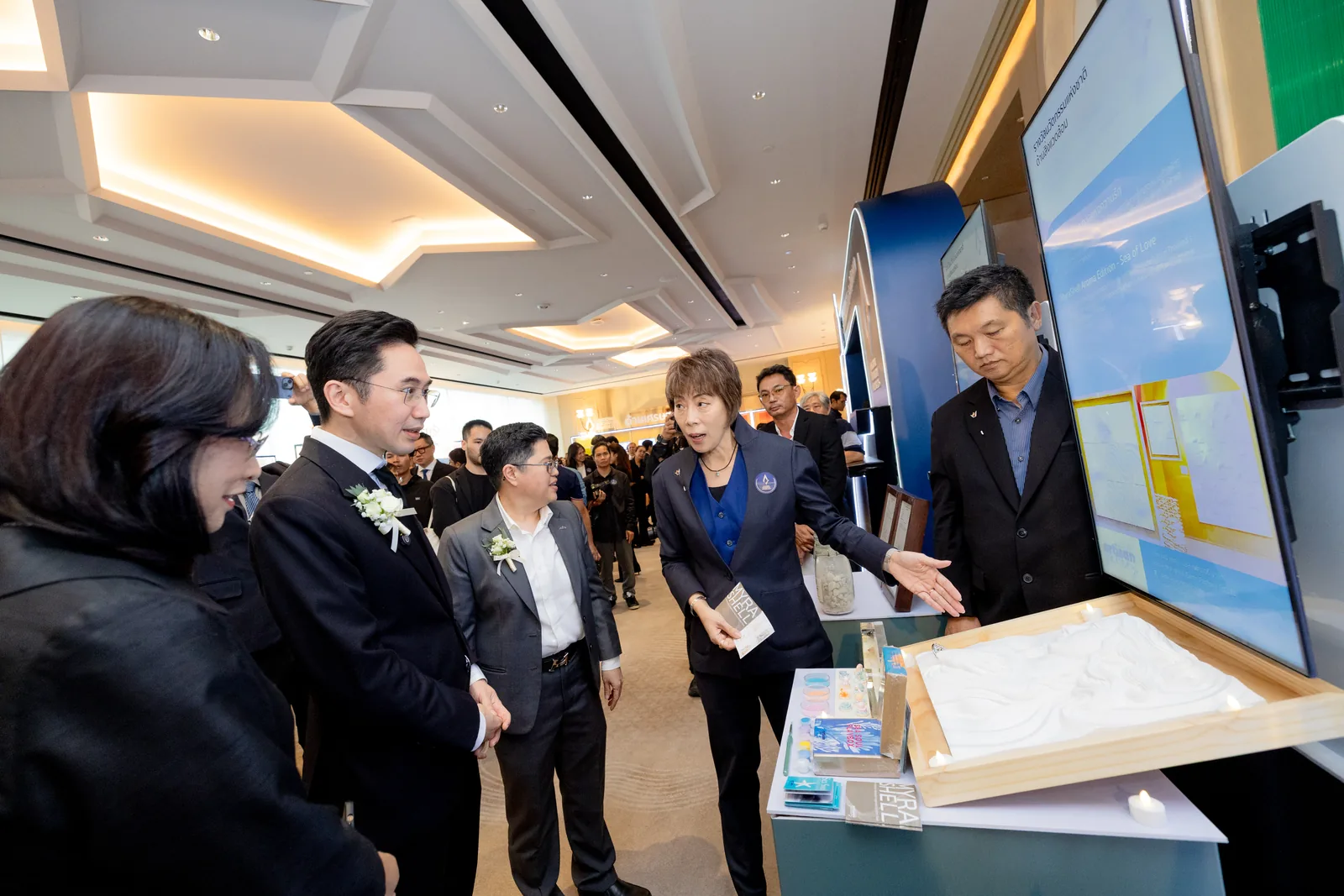 Guests at the booth beside the material display