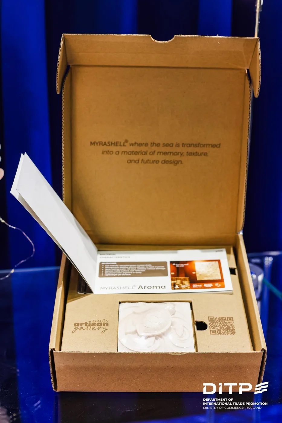 The MyraShell Aroma box, open, with a sea turtle relief tile