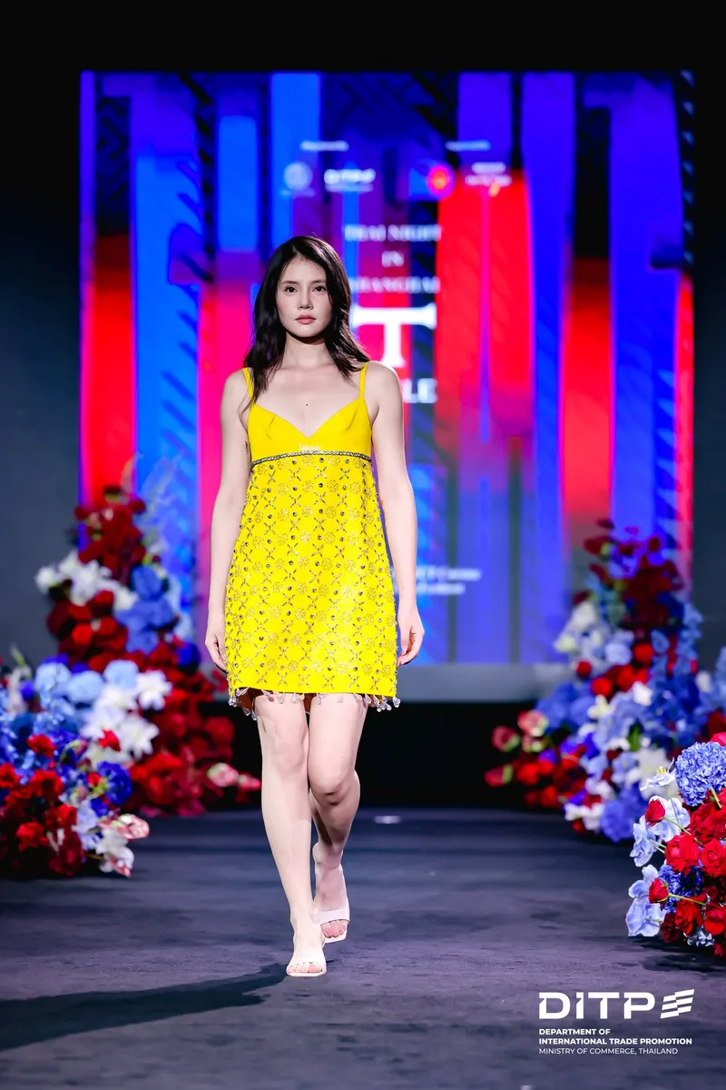 A model in a yellow dress on the runway
