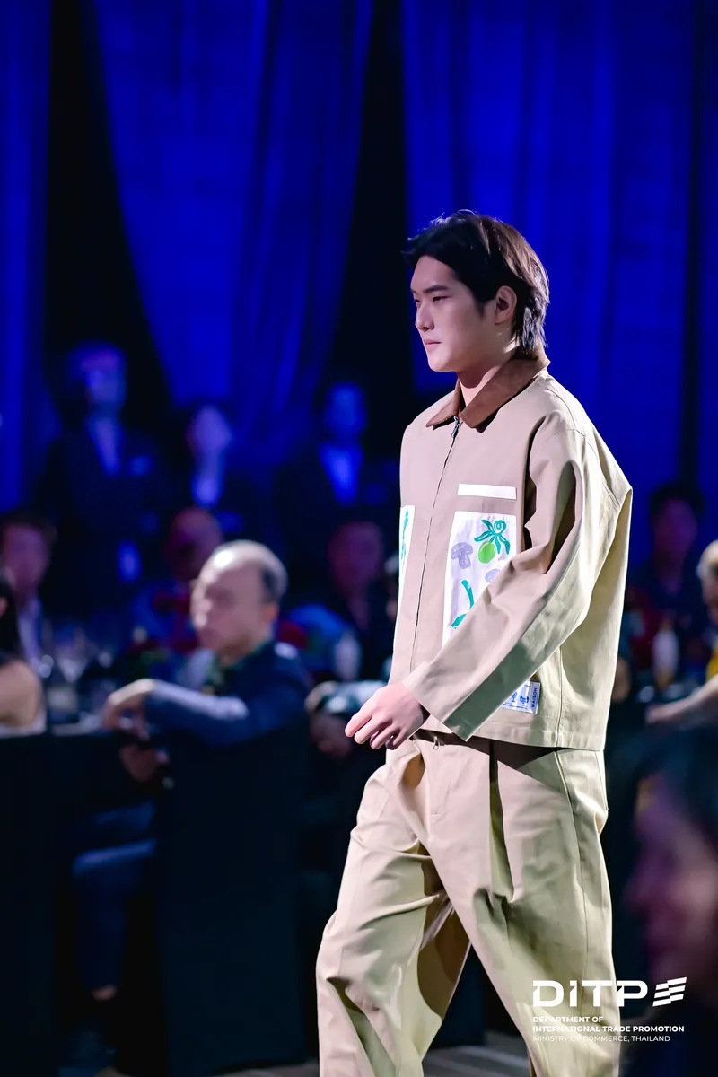 A model in a green jacket and trousers