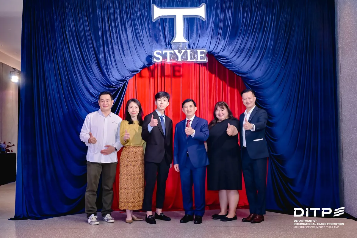 A group photo in front of the T-STYLE curtain