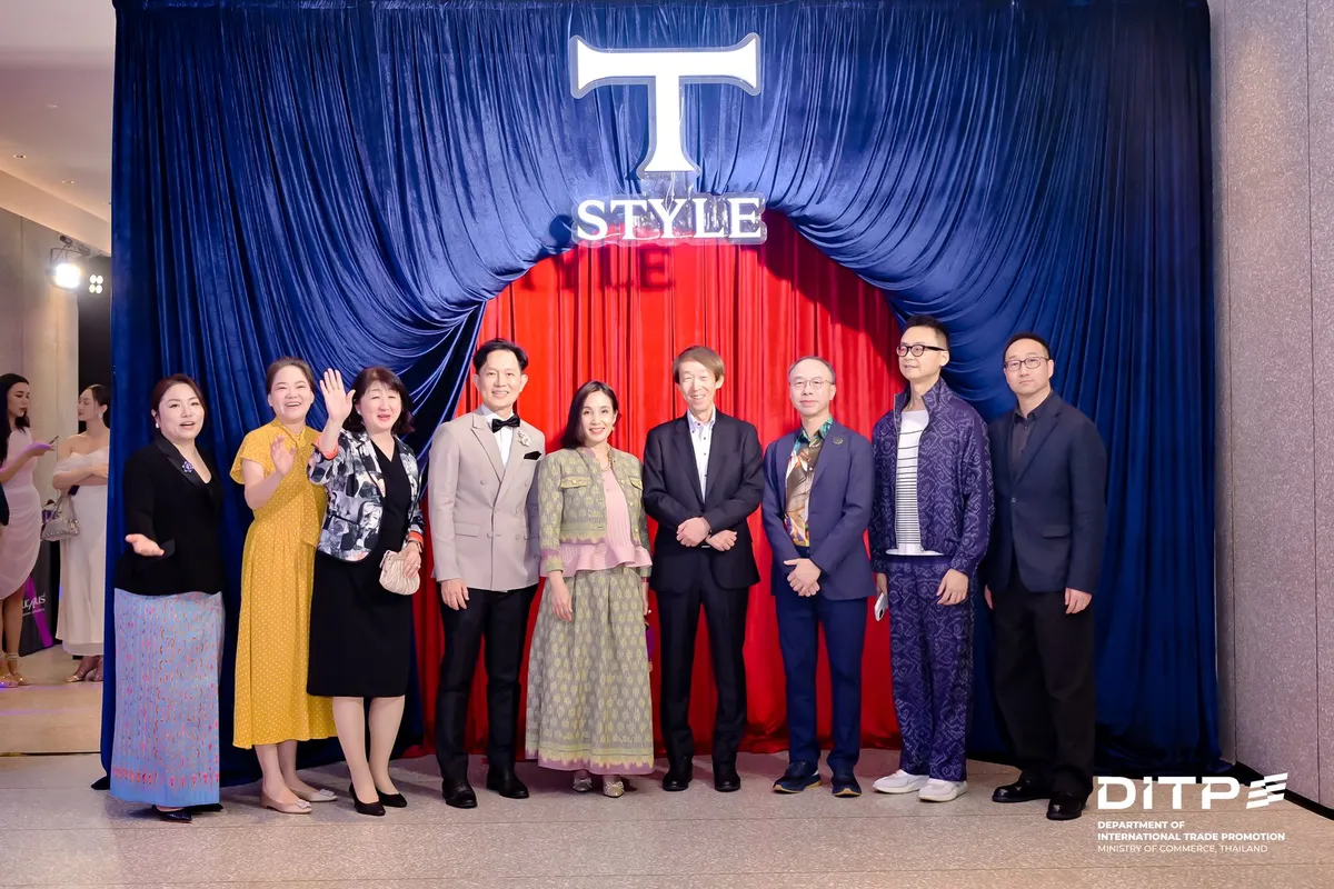 A large group photo in front of the T-STYLE curtain