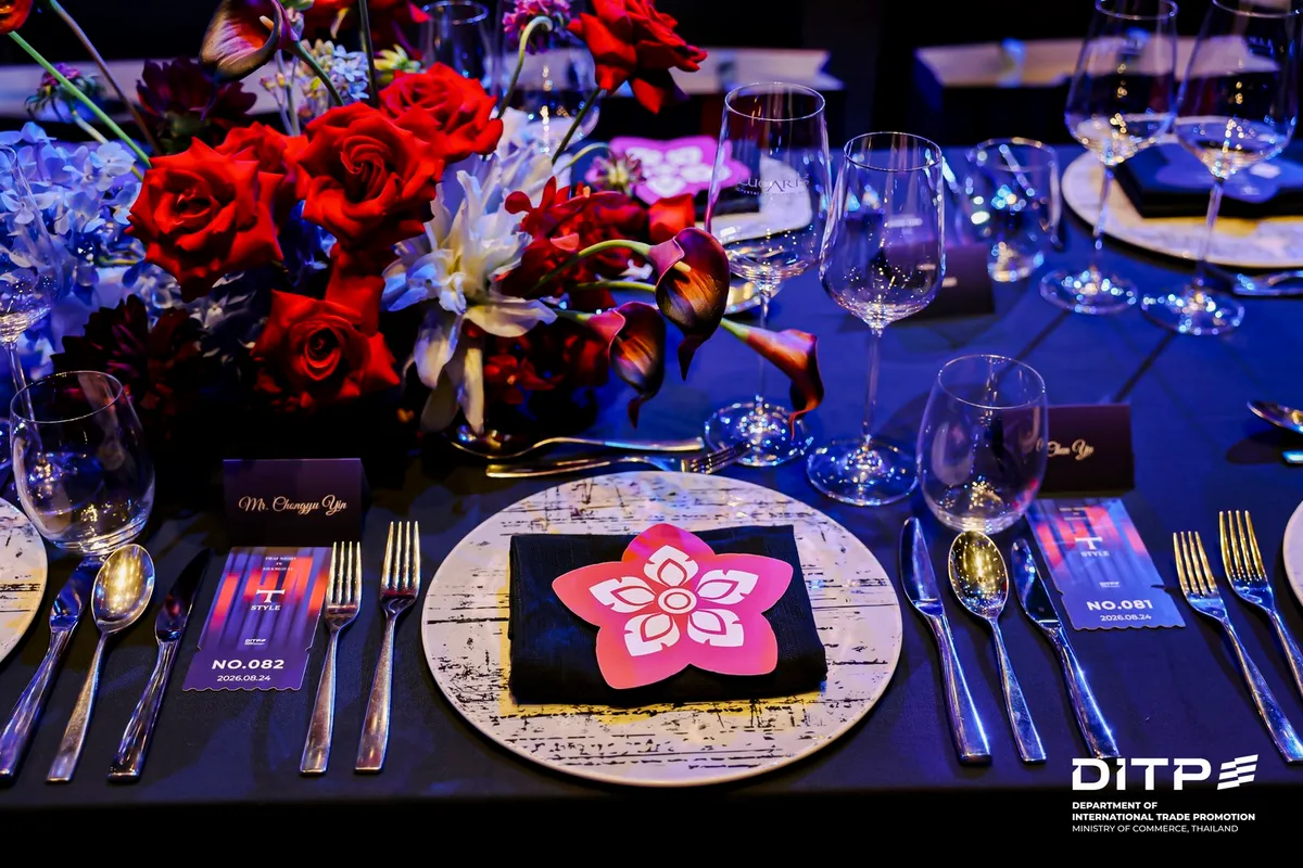 A place setting with flowers on a dinner table