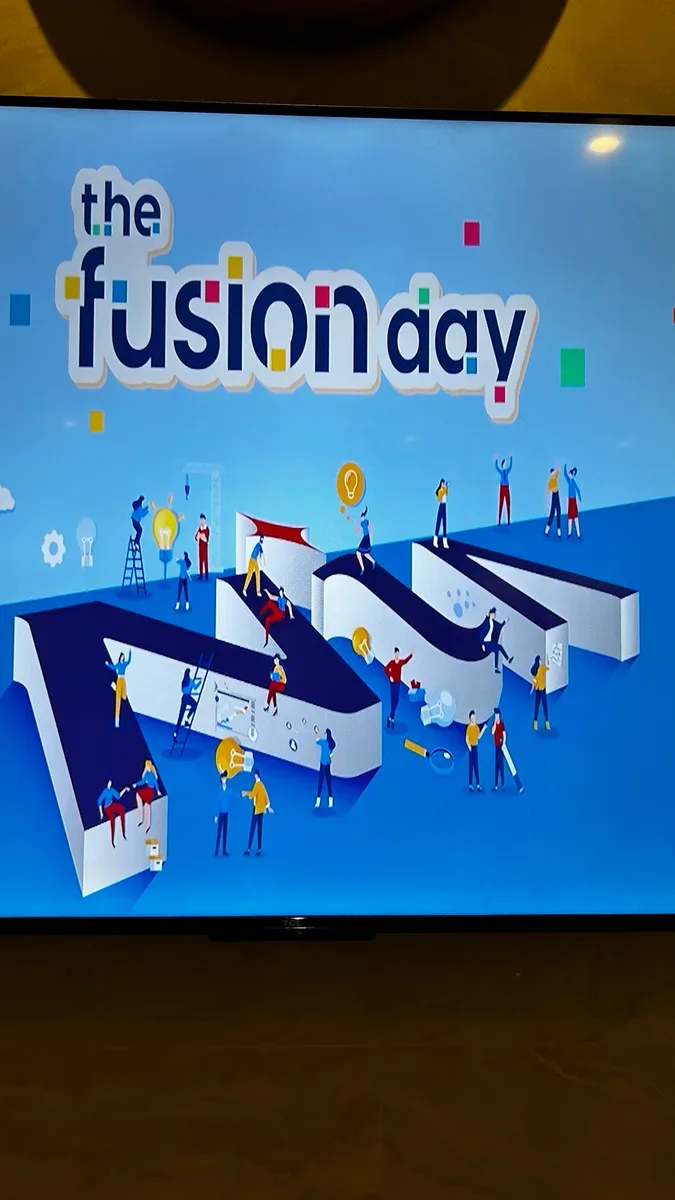 The Fusion Day title on a screen at the event